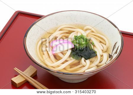 Japanese Kake Udon Noodles In A Ceramic Bowl On White Background