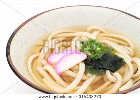Japanese Kake Udon Noodles In A Ceramic Bowl On White Background