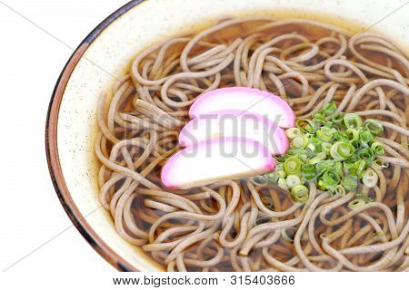 Japanese Kake Soba Noodles In A Ceramic Bowl On White Background