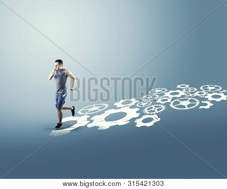 Man Running Through On A Engine Gear Wheels. The Concept Of Shortcut And Working Smart.