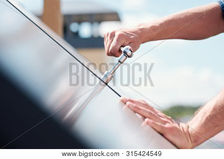 Hand of technician master turning steel handle or worktool