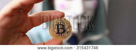 Minsk, Belarus, June, 2019: Hacker Wear Anonymus Mask Hold Bitcoin In Hand Illustrative Editorial