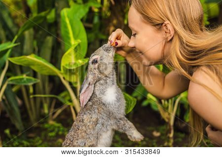 Woman Holding A Rabbit. Cosmetics Test On Rabbit Animal. Cruelty Free And Stop Animal Abuse Concept