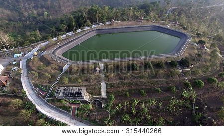 Design Of A Rain-fed Reservoir On A Plantation Hill View From Above With Aerial Drone Camera