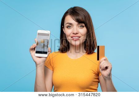 Happy young buyer and online shop client with credit card showing you promo