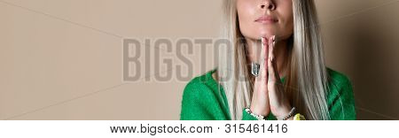 Indoor Shot Of Regretful Woman Keeps Palms Together, Beggs For Something, Feels Sorry And Guilty. Cu