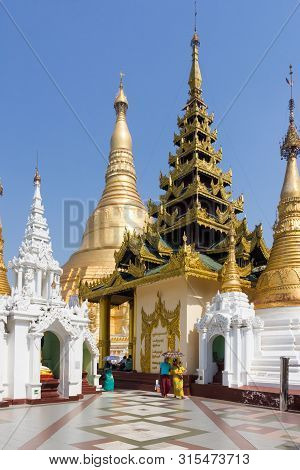 Yangon, Myanmar-may 6th 2014: Burmese People Walk Through Shwedagon Pagoda. The Pagoda Is The Most S
