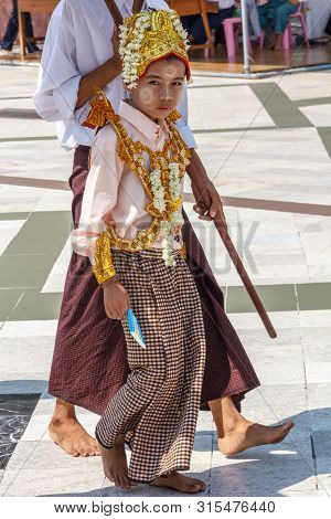 Yangon, Myanmar-may 6th 2014: Girl Dressed For Religious Ceremony In Shwedagon Pagod. The Pagoda Is 