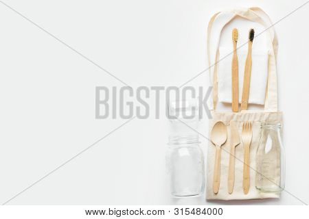 Cotton, Cloth Fabric Tote Shopping Bag Bamboo Toothbrushes Wooden Cutlery Glass Bottle Jar On White 