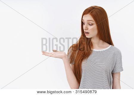 Surprised Wondered Cute Tender Redhead Girl Hold Object Palm Look Curious Intrigued Drop Jaw Interes
