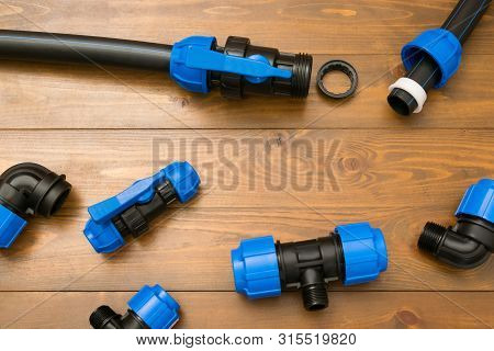 Spare Parts For Summer Water Supply In A Country House On A Dark Wooden Background