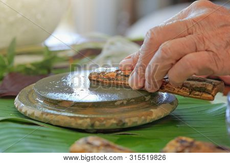 Thanaka Herb Bark Scrubbing On Kyauk Pyin Stone Slab . Thanaka Is A Popular Cosmetic Paste Made From