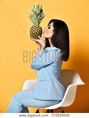 Stylish Woman Brunette With Long Straight Hair In Blue Official Suit Jacket And Pants Sitting In Whi