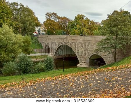 Walking Path Along The River In City In Autumn. River Akerselva And Bridge In Oslo, Norway.