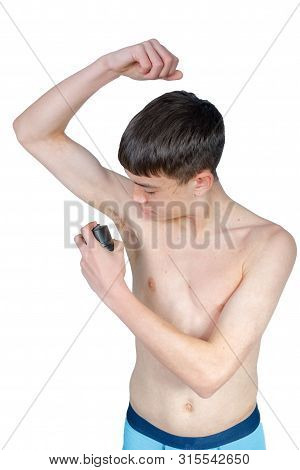 Teenage Boy Using An Under Arm Spray Isolated On A White Background