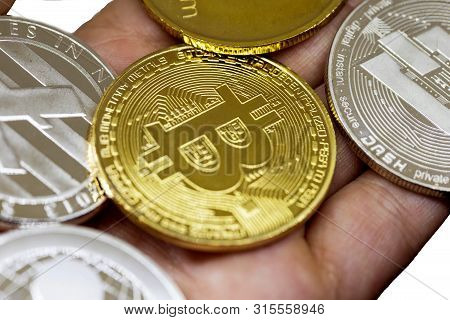 Golden Bitcoin In A Man Hand, Digitall Symbol Of A New Virtual Currency