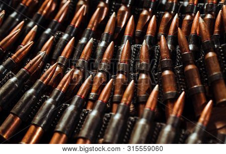 Bullets On A Wooden Background. Military Concept.