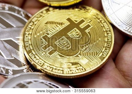 Golden Bitcoin In A Man Hand, Digitall Symbol Of A New Virtual Currency