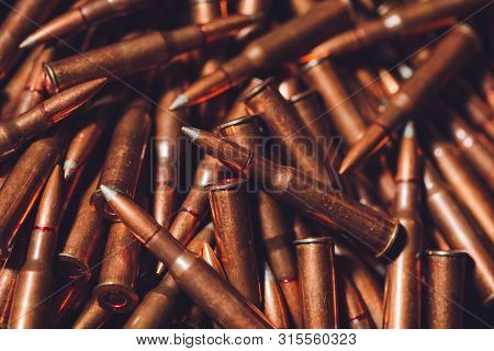 Bullets On A Wooden Background. Military Concept.
