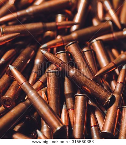 Bullets On A Wooden Background. Military Concept.