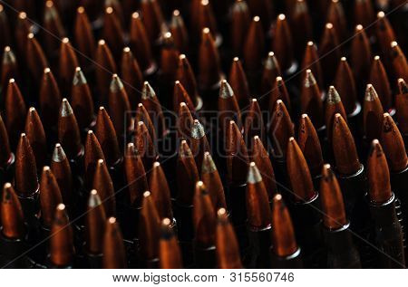 Bullets On A Wooden Background. Military Concept.