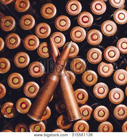 Bullets On A Wooden Background. Military Concept.
