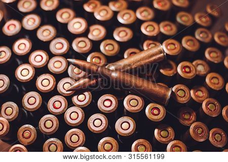 Bullets On A Wooden Background. Military Concept.