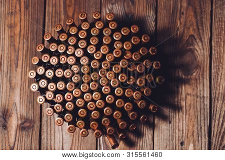 Bullets On A Wooden Background. Military Concept.