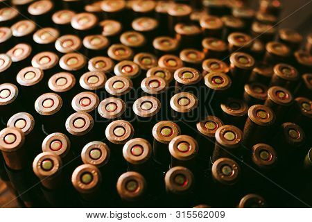 Bullets On A Wooden Background. Military Concept.