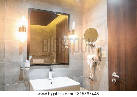 Washbasin With Mirrow In The Hotel Bathroom