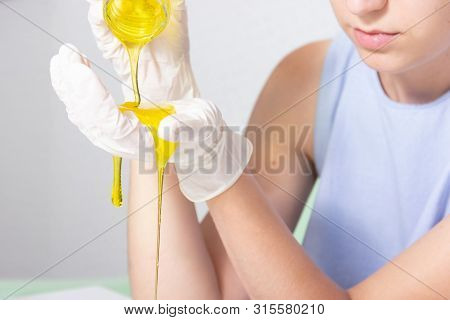 Young Beautiful Girl Shows How To Make Slime. Yellow Homemade Slime Is A Children's Toy. Composition