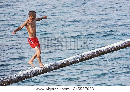 Xghajra, Malta - August 3, 2019: Traditional Maltese Game Of Gostra, Where Is Brave Local Men Would 