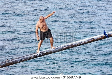 Xghajra, Malta - August 3, 2019: Traditional Maltese Game Of Gostra, Where Is Brave Local Men Would 