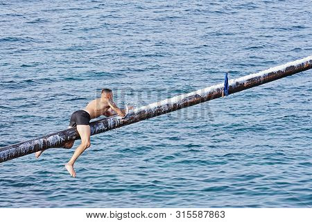 Xghajra, Malta - August 3, 2019: Traditional Maltese Game Of Gostra, Where Is Brave Local Men Would 