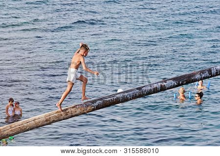 Xghajra, Malta - August 3, 2019: Traditional Maltese Game Of Gostra, Where Is Brave Local Men Would 