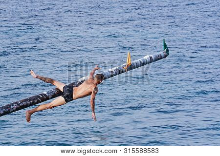 Xghajra, Malta - August 3, 2019: Traditional Maltese Game Of Gostra, Where Is Brave Local Men Would 