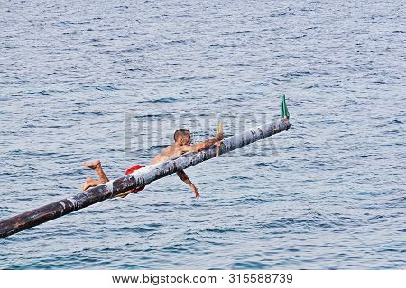 Xghajra, Malta - August 3, 2019: Traditional Maltese Game Of Gostra, Where Is Brave Local Men Would 