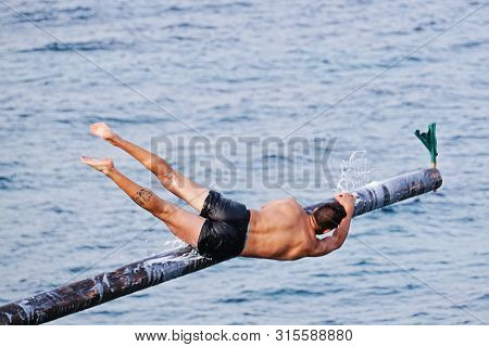 Xghajra, Malta - August 3, 2019: Traditional Maltese Game Of Gostra, Where Is Brave Local Men Would 