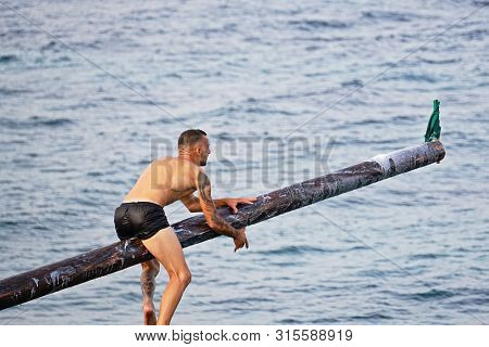 Xghajra, Malta - August 3, 2019: Traditional Maltese Game Of Gostra, Where Is Brave Local Men Would 