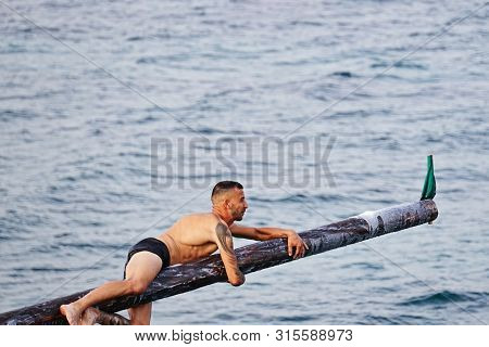 Xghajra, Malta - August 3, 2019: Traditional Maltese Game Of Gostra, Where Is Brave Local Men Would 
