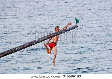 Xghajra, Malta - August 3, 2019: Traditional Maltese Game Of Gostra, Where Is Brave Local Men Would 