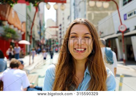 Happy Beautiful Smiling Girl Walking In Sao Paulo Japanese Neighborhood Liberdade, Sao Paulo, Brazil