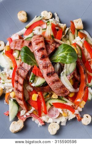 Salad With Grilled Sausage Paprica Cucumber And Croutons