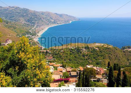 Beautiful Landscape Panorama Of Sicily Coastline. Blue Mediterranean Sea And Green Mountians, Taormi