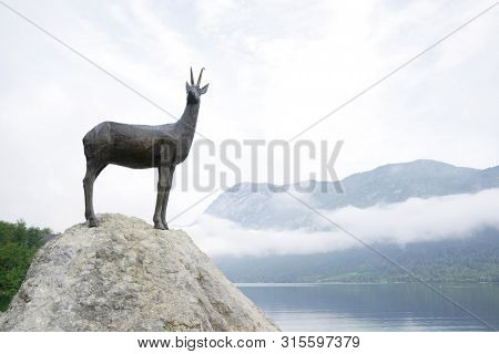 BOHINJ LAKE, SLOVENIA - JULY 28, 2019: Bronze statue of the legendary deer Zlatorog (The Golden Horn) 