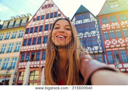 Beautiful Smiling Woman Take Self Portrait In Romerberg Square In Frankfurt, Germany
