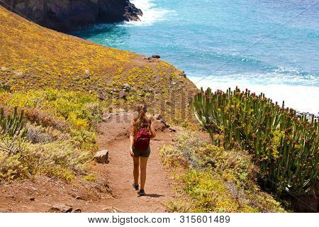 Back View Young Female Hiker Walking Down To The Sea On Macizo De Anaga In Tenerife