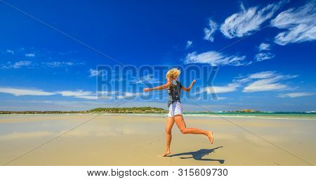 Active Woman Running On Seashore Of Madfish Bay In William Bay National Park, Denmark Region, Wester