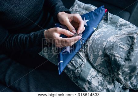 Cropped View Of Woman On Couch With Military Clothing, Tag Dog And Foded American Flag At Home