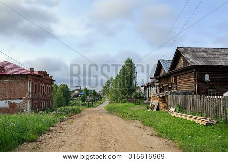 Country Road In Summer. View Of The Old Residential Neighborhood. Village Of Visim, Sverdlovsk Regio